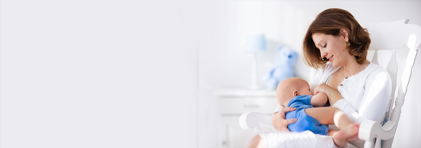 Mother breastfeeding her baby in a bright nursery